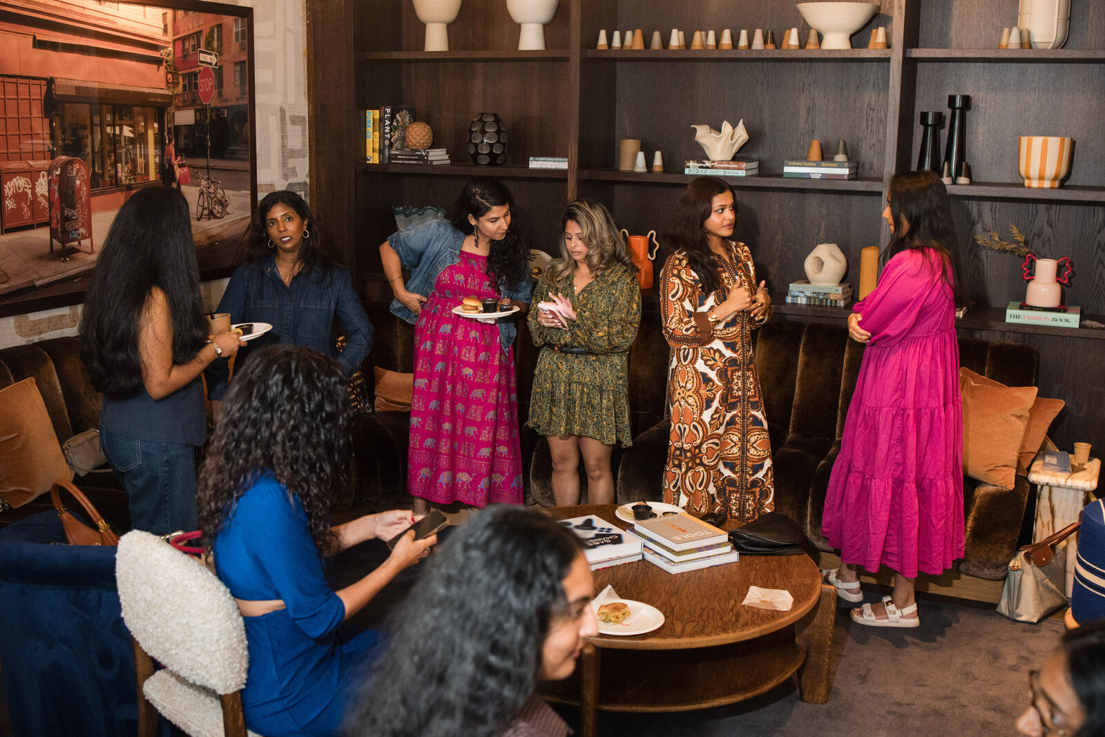 A room of women leaning in, listening to a speaker at a Brown Girls Money Moves session