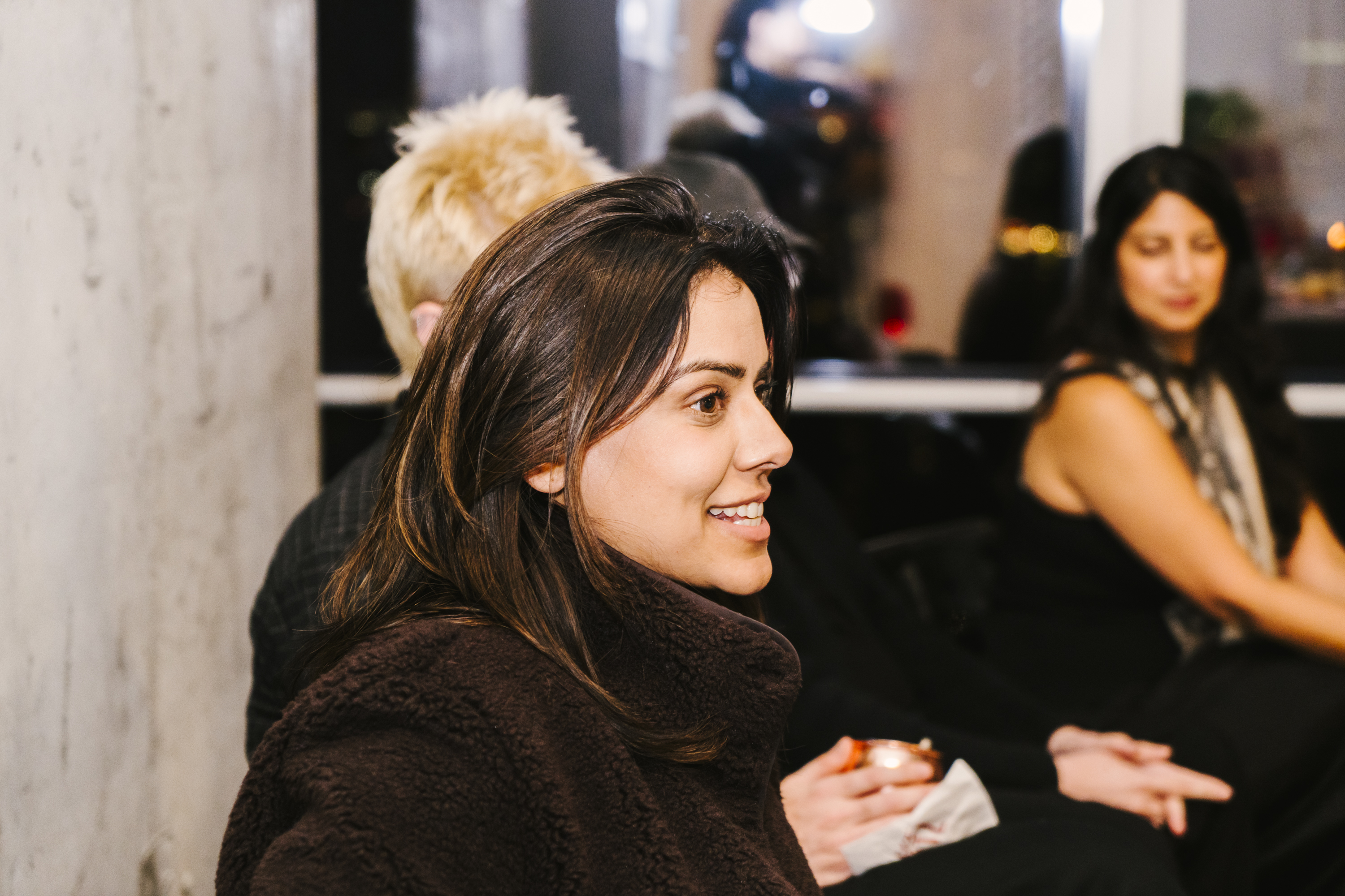 A close candid moment of laughter at the Brown Girl Angels SickKids fundraiser — the part of the room that doesn't get photographed enough.