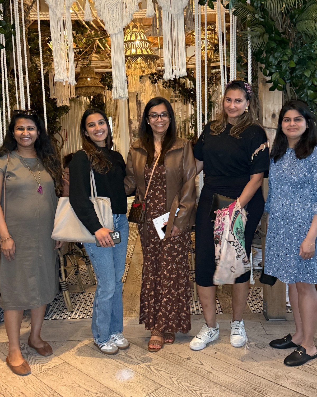 Brown Girls in a macrame-lit room — community in a beautifully produced space